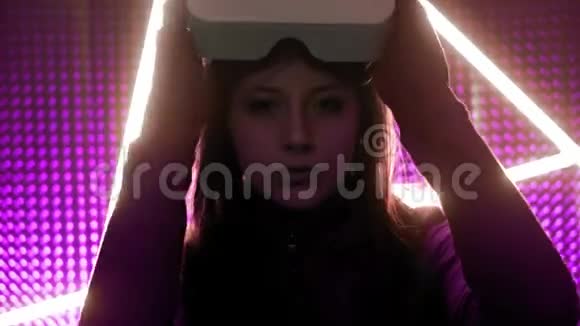 年轻女孩职业玩家戴虚拟现实眼镜沉浸在平行的现实中创造建筑视频的预览图