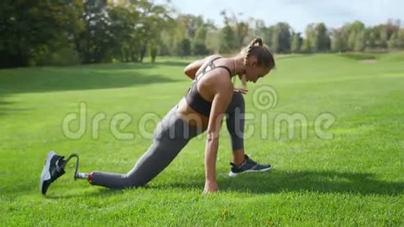 残疾妇女在公园里伸腿女运动员晨练视频的预览图