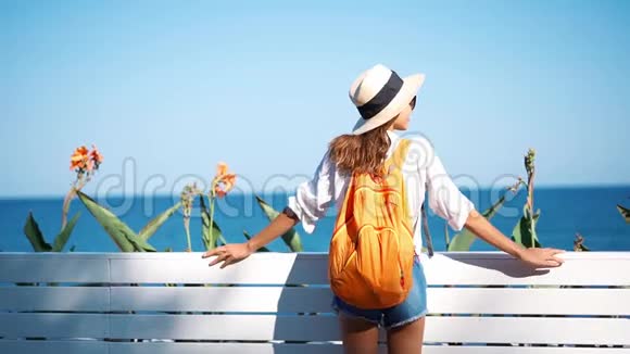 阳光明媚的海边慢镜头特写迷人的快乐女孩旅游草帽和眼镜视频的预览图