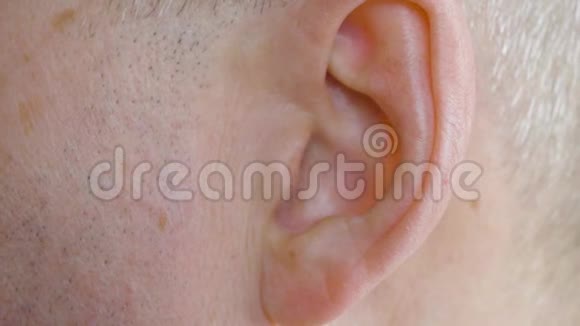 男性耳朵贴紧近距离观察人移动他的耳朵身体部分视频的预览图