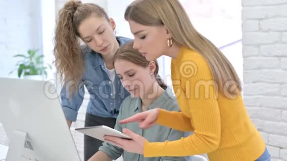 努力工作的女性创业团队使用平板电脑和桌面视频的预览图