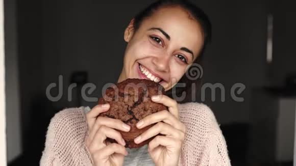 快乐微笑的女人吃大块巧克力饼干的肖像视频的预览图