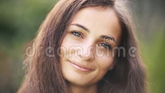 美丽的白人女人对着镜头微笑视频的预览图