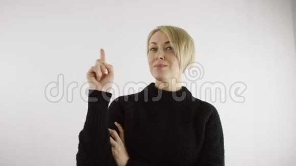成年白种人金发短发女子指着她的食指在白色背景上做笔记视频的预览图
