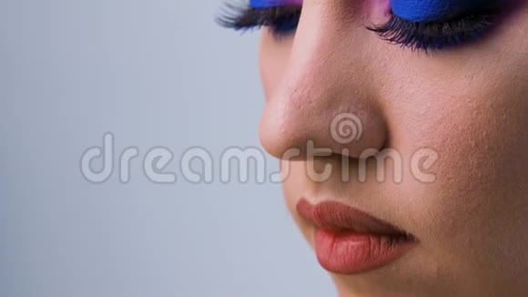 迷人明亮的眼妆采用潮流色彩经典蓝色女性眼睛特写视频的预览图