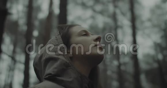 小女孩站在森林中的特写肖像倾听周围的鸟类和自然美丽的女人视频的预览图
