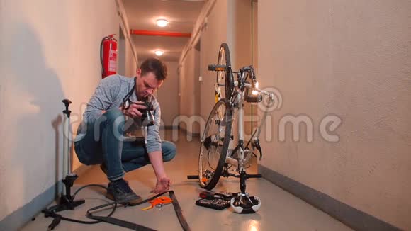 一个视频博客写手制作视频并在车库修理自行车轮子视频的预览图