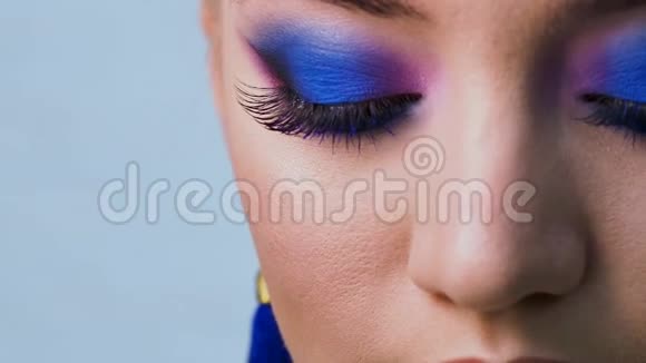 迷人明亮的眼妆采用潮流色彩经典蓝色女性眼睛特写视频的预览图