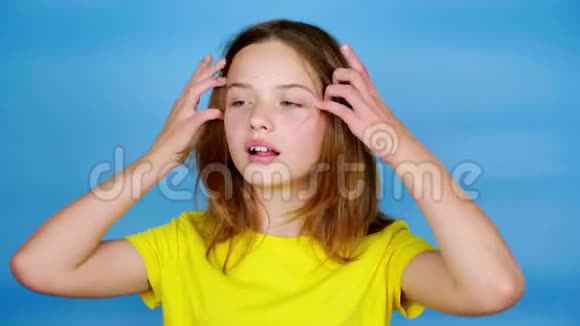 一个穿黄色T恤的少女正正着头发说话视频的预览图