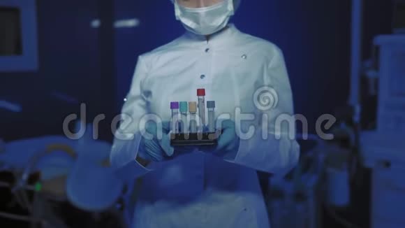 年轻女医生戴着医用面具看镜头的肖像医生手里拿着锥子视频的预览图