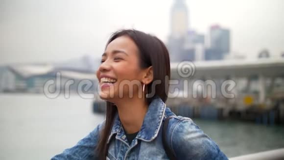 迷人的年轻亚洲女人在码头边听朋友的笑声视频的预览图