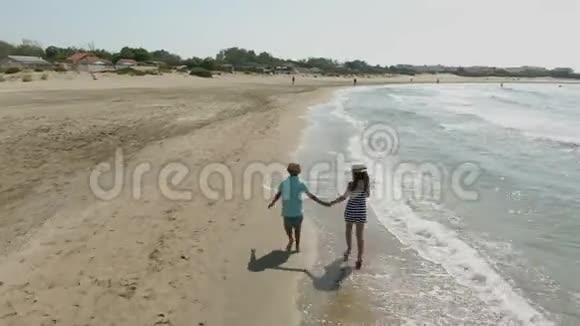 两个孩子在海滩上的空中射击视频的预览图