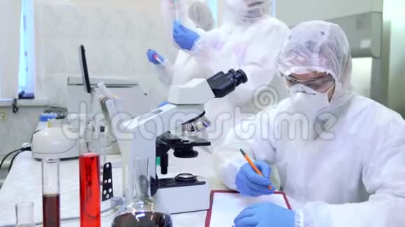 科学实验室里穿着防护服的科学家研究了一种危险的病毒来消除这种流行病视频的预览图