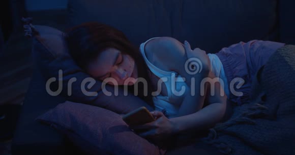 从上面看年轻的不眠女躺在沙发上在电话屏幕上主演失落的千禧女孩视频的预览图