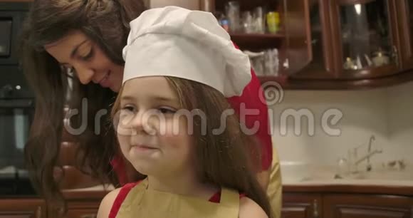 成年白种人女人穿上围裙戴着白色厨师帽亲吻她幸福的特写肖像视频的预览图