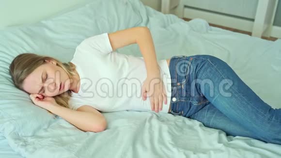 肚子疼的女人躺在床上视频的预览图