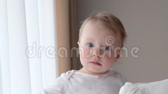 她妈妈怀里的小女孩靠近窗户视频的预览图