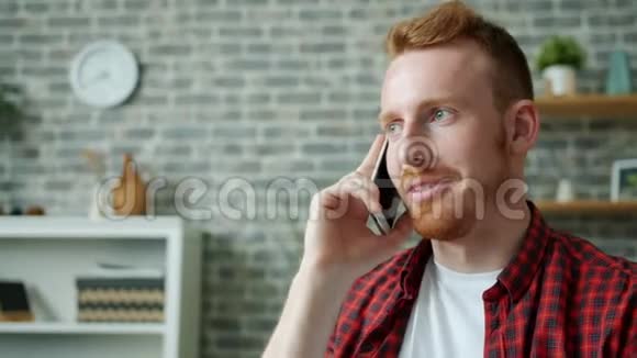 长得好看的大胡子男在公寓里用手机聊天视频的预览图