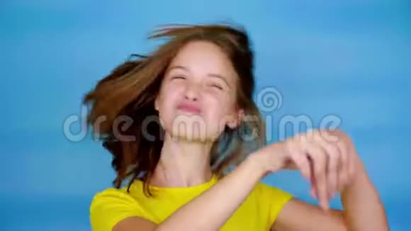 穿着黄色T恤的快乐少女正在跳舞微笑着到处是傻瓜视频的预览图