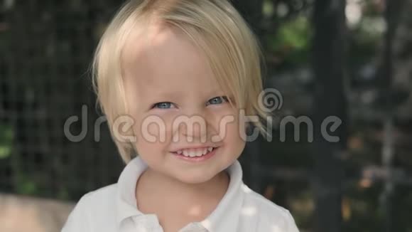 3岁的小男孩留着白发对着镜头微笑视频的预览图