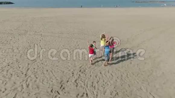 穿着鲜艳衣服的孩子们在海滩上跳舞视频的预览图