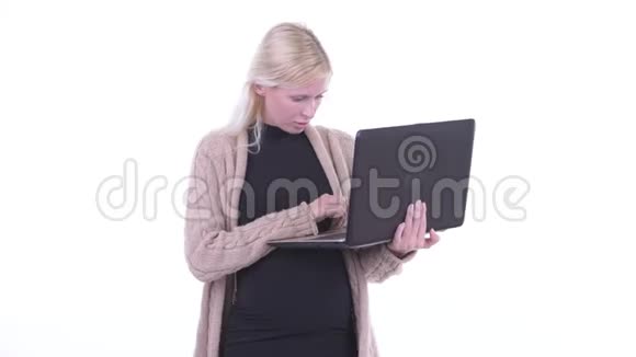 快乐的年轻金发孕妇视频通话笔记本电脑视频的预览图