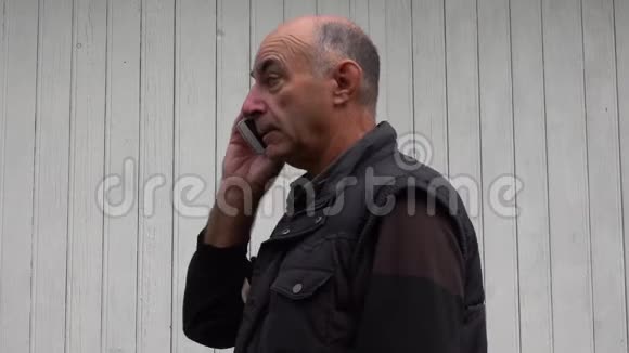 一个年长的男人用手机说话视频的预览图