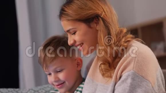 母子俩在家里用平板电脑视频的预览图