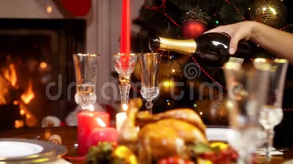 在圣诞晚餐时用玻璃倒香槟的特写镜头视频的预览图