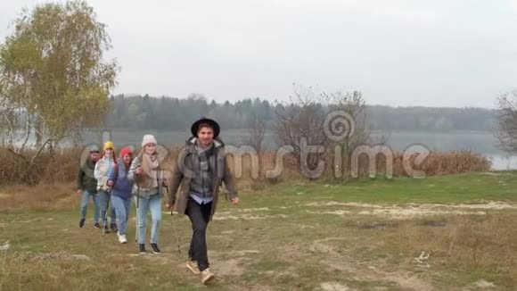 旅行朋友带着背包在自然背景NN上行走挥舞着手视频的预览图