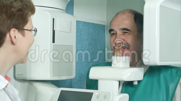 使用全景和头影X射线扫描仪在检查前与资深病人交谈视频的预览图