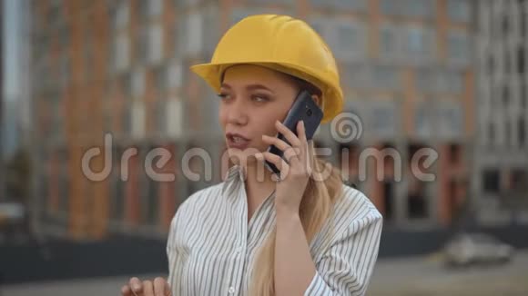 特写商务女工程师打电话戴着4K安全帽的女士视频的预览图