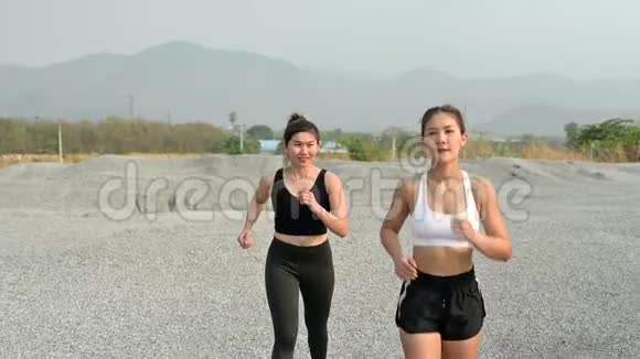 慢动作运动员女人在岩石上跑步亚洲女跑运动员夏季耐力训练视频的预览图