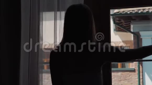 女人想呼吸早晨的空气打开窗户视频的预览图