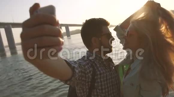 浪漫的情侣在阳光下在桥边拍照视频的预览图