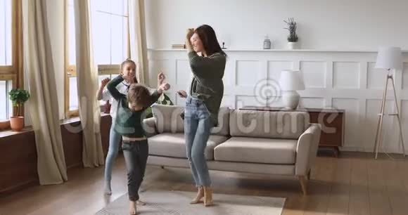 快乐的单身妈妈和有趣的孩子在家跳跳舞视频的预览图