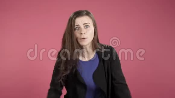 愤怒的女人尖叫着用手在粉红色的背景下做手势视频的预览图