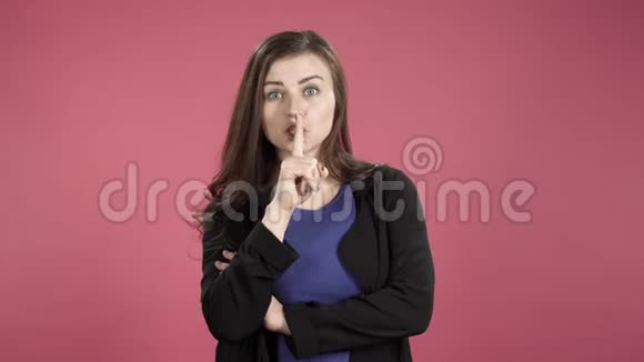 嘴唇上有手指的严格女人的肖像年轻的女人要求沉默做一个安静的手势视频的预览图