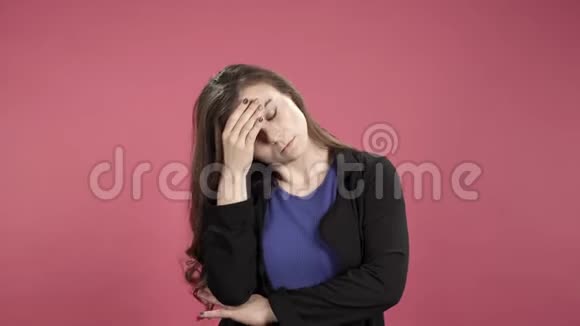 年轻有压力的女性因粉红色背景而头痛视频的预览图