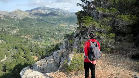 探索旅行目的地概念徒步旅行女人与背包在岩石的观点在马洛卡岛山脉视频的预览图