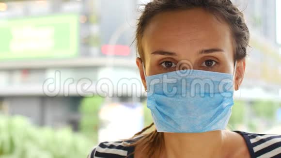 女性戴上口罩以防冠状病毒视频的预览图