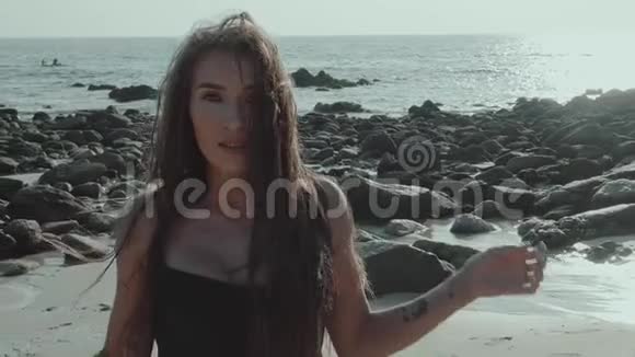 海滩上漂亮的黑发女人视频的预览图