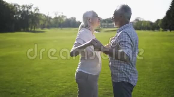 积极的成熟夫妻在草坪上跳舞唱歌视频的预览图