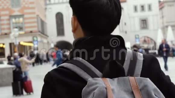 亚洲青年游客在欧洲市中心旅游在慕尼黑Marienplatz广场散步的男性背包客视频的预览图