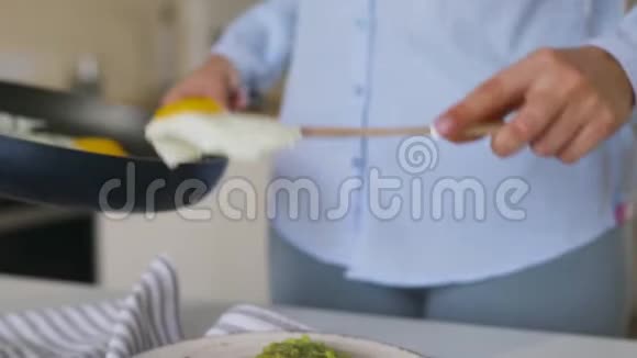 女人把煎鸡蛋和鳄梨吐司放在盘子里健康素食早餐视频的预览图