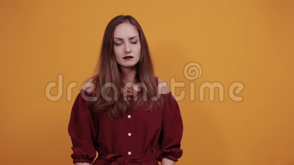 穿着栗色连衣裙的患病妇女双手抱头头痛视频的预览图
