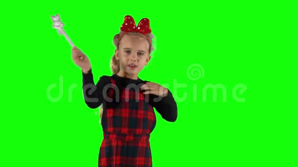 金发魔术师女孩手里拿着魔杖说着咒语看着镜头视频的预览图