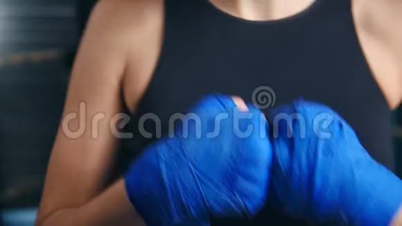 贴身女战士穿黑色运动服打防护mma包手准备冲拳视频的预览图