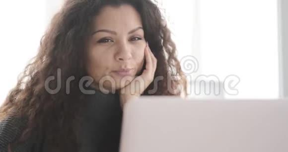 女商人用办公笔记本电脑喝咖啡和视频聊天视频的预览图