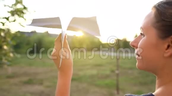女人在日落的背景下发射纸飞机梦想旅行或空姐的职业视频视频的预览图